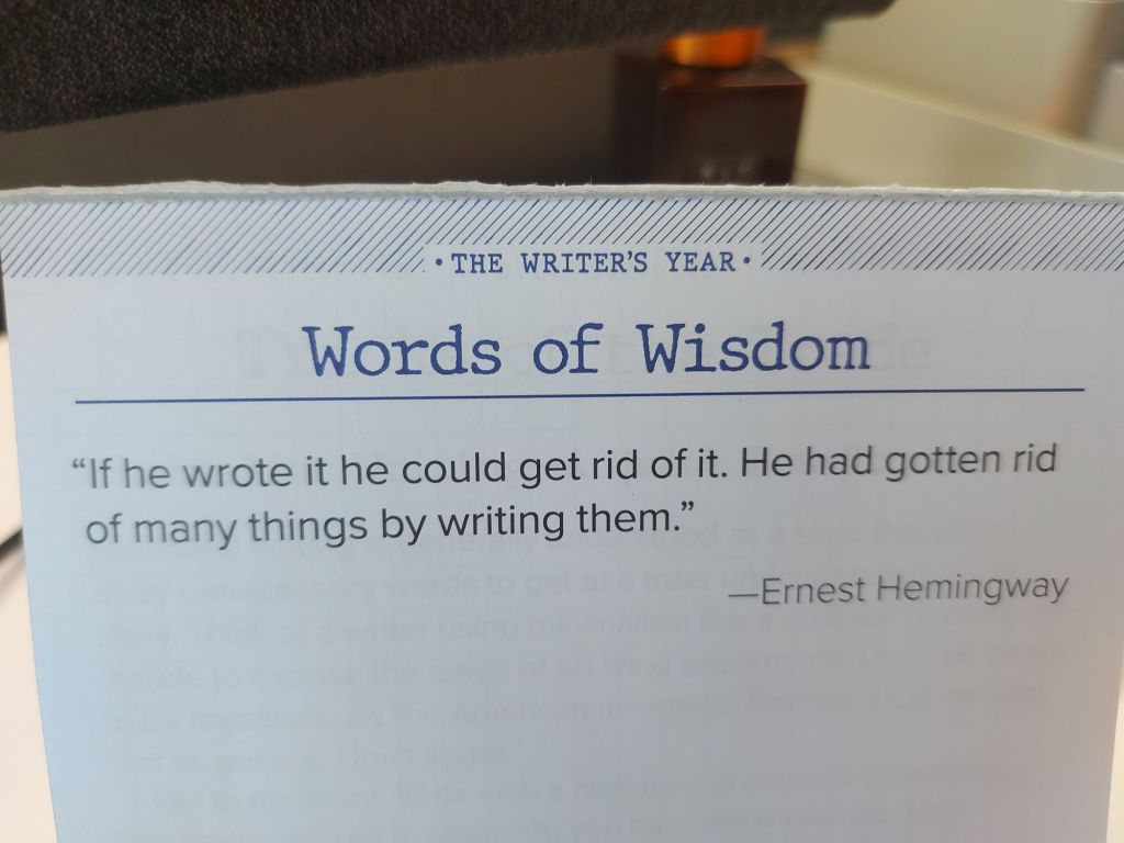 A picture of my quote of the day calendar with a quote from Ernest Hemingway: "If he wrote it he could get rid of it. He had gotten rid of many things by writing them" 