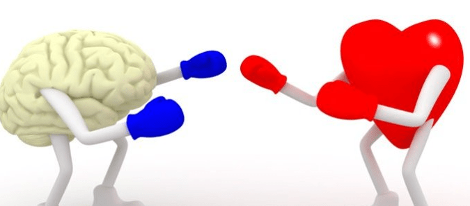 An image showing a brain with hands and boxing gloves squaring off against a heart with hands and boxing gloves... Coaching needs you to engage your heart as well as your head. 